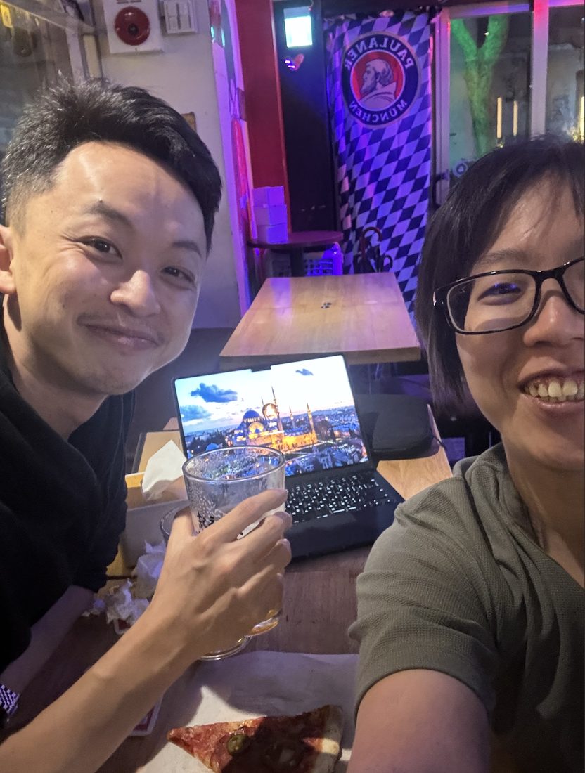 A remote worker with a laptop and a drink at a bar in Taipei